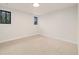 Bright bedroom featuring neutral carpet, two small windows, and recessed lighting at 4656 Tanglewood Trl, Boulder, CO 80301