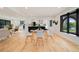 Bright, open-concept dining room with modern white table set and natural light from large windows at 4656 Tanglewood Trl, Boulder, CO 80301