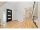 Inviting entryway featuring wood floors, contemporary door, and access to multiple rooms at 4656 Tanglewood Trl, Boulder, CO 80301
