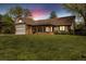 Charming single-story home with brick accents, arched porch, two-car garage, and lush lawn at 4656 Tanglewood Trl, Boulder, CO 80301
