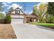 Charming exterior with brick facade, arched entryway, white garage door, and well-manicured lawn at 4656 Tanglewood Trl, Boulder, CO 80301