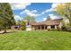 Charming single-story home with brick accents, arched porch, two-car garage, and lush lawn at 4656 Tanglewood Trl, Boulder, CO 80301