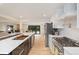 Open concept kitchen featuring a large center island, stainless appliances, and hardwood flooring throughout at 4656 Tanglewood Trl, Boulder, CO 80301