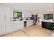 Bright kitchen boasting white cabinets, stainless steel refrigerator, and hardwood floors at 4656 Tanglewood Trl, Boulder, CO 80301