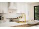 Modern kitchen featuring white cabinetry, stainless steel appliances, and a stylish gold faucet at 4656 Tanglewood Trl, Boulder, CO 80301