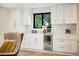 Tastefully designed kitchen featuring white cabinets, a wine cooler, and hardwood floors at 4656 Tanglewood Trl, Boulder, CO 80301