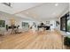 Bright, open-concept living room featuring hardwood floors, modern fireplace, and seamless flow to the kitchen at 4656 Tanglewood Trl, Boulder, CO 80301