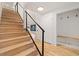 Stylish staircase with wood steps, and modern black railing leading to upper level at 4656 Tanglewood Trl, Boulder, CO 80301