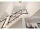 Modern staircase showcasing an open design with metal railings and a unique chandelier fixture at 4656 Tanglewood Trl, Boulder, CO 80301
