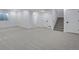 Basement featuring neutral carpet, white trim, and doors leading to additional spaces and stairs at 3336 N Haleyville Ct, Aurora, CO 80019