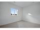 Bright bedroom featuring a large window and neutral carpet at 3336 N Haleyville Ct, Aurora, CO 80019