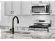 Kitchen featuring stainless steel appliances, granite countertops and backsplash at 3336 N Haleyville Ct, Aurora, CO 80019