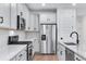 Well-lit kitchen featuring stainless steel appliances, white cabinets, granite countertops and backsplash at 3336 N Haleyville Ct, Aurora, CO 80019