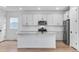 Kitchen featuring a large kitchen island with a sink, granite countertops, and stainless steel appliances at 3336 N Haleyville Ct, Aurora, CO 80019