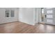Bright living room featuring hardwood floors, white walls and a large window at 3336 N Haleyville Ct, Aurora, CO 80019