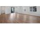 Bright and airy living room features wood floors, large windows, and neutral walls for a modern feel at 3336 N Haleyville Ct, Aurora, CO 80019