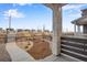 Inviting porch view with stone column, iron railing, and landscaped front yard at 3336 N Haleyville Ct, Aurora, CO 80019