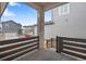 Inviting porch view with stone column, iron railing, and view of neighborhood homes at 3336 N Haleyville Ct, Aurora, CO 80019