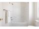 Clean bathroom showcases tub, tiled walls and a white towel at 4555 Andes St, Denver, CO 80249