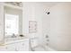 Bright bathroom with white tiled shower and tub and modern vanity with sink at 4555 Andes St, Denver, CO 80249
