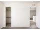 Bedroom with neutral carpet, walk-in closet, and ensuite at 4555 Andes St, Denver, CO 80249
