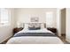 Bright bedroom featuring plush bedding, bedside tables, and natural light at 4555 Andes St, Denver, CO 80249