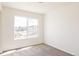 Well-lit bedroom with neutral carpet and large window providing ample natural light at 4555 Andes St, Denver, CO 80249