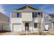 Charming two-story home featuring red shutters, vinyl siding, and an attached one car garage at 4555 Andes St, Denver, CO 80249