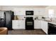 Well-appointed kitchen featuring modern appliances, ample counter space, and sleek white cabinetry at 4555 Andes St, Denver, CO 80249