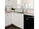 Modern kitchen sink with quartz countertops, subway tile backsplash, and a stainless steel dishwasher at 4555 Andes St, Denver, CO 80249