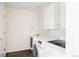 Bright laundry room features modern washer and dryer, upper cabinets, and convenient sink at 4555 Andes St, Denver, CO 80249