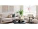 Comfortable and stylish living room boasting natural light, soft textures, and modern decor at 4555 Andes St, Denver, CO 80249