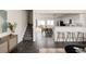 Bright living room showcasing modern tile floors, staircase and seamlessly connecting to the dining area at 4555 Andes St, Denver, CO 80249