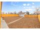 Spacious backyard with a detached garage and wooden fence at 5030 N Bryant, Denver, CO 80221