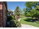 Expansive backyard featuring a lush lawn, mature trees, patio, and pergola, perfect for outdoor living and entertaining at 1193 Phipps Ct, Highlands Ranch, CO 80126