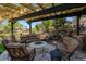 Backyard patio features a seating area with a fire pit and a rock water feature at 1193 Phipps Ct, Highlands Ranch, CO 80126