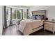 Bedroom features a large bay window, wood floors and neutral decor providing a serene and relaxing space at 1193 Phipps Ct, Highlands Ranch, CO 80126