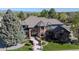Beautiful two-story home showcasing a manicured lawn, stone pathway, and mature trees at 1193 Phipps Ct, Highlands Ranch, CO 80126