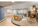 Spacious game room features a billiards table and cozy seating area with a custom curved couch at 1193 Phipps Ct, Highlands Ranch, CO 80126