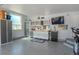 Well-equipped garage with workbench, cabinets, and TV for hobby enthusiasts at 1193 Phipps Ct, Highlands Ranch, CO 80126