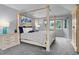Serene main bedroom features a four-poster bed and tranquil backyard views at 1193 Phipps Ct, Highlands Ranch, CO 80126