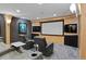 Home theater room with comfortable seating, large screen and media cabinet with accent lights creating the perfect viewing experience at 1193 Phipps Ct, Highlands Ranch, CO 80126