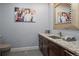 Stylish powder room with granite countertop, contemporary fixtures and decor at 1193 Phipps Ct, Highlands Ranch, CO 80126