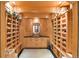 A custom wine cellar features wood shelving and storage space to house a large wine collection at 1193 Phipps Ct, Highlands Ranch, CO 80126