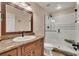 Well-lit bathroom featuring a glass enclosed shower with bench, a granite countertop and modern fixtures at 11 Canon Pl, Greenwood Village, CO 80111