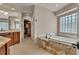 Luxurious bathroom boasting a soaking tub with granite surround and access to the custom walk-in closet at 11 Canon Pl, Greenwood Village, CO 80111