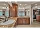 Elegant bathroom featuring custom cabinets, granite countertops, and a walk-in closet at 11 Canon Pl, Greenwood Village, CO 80111