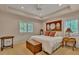 Comfortable bedroom with tray ceiling, ceiling fan, natural light, and decorative headboard with mirrors at 11 Canon Pl, Greenwood Village, CO 80111