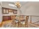 Elegant dining room with chandelier, built-in cabinet, and hardwood floors at 11 Canon Pl, Greenwood Village, CO 80111