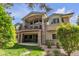 Elegant two-story home with stone accents, balcony, and beautifully landscaped yard, creating curb appeal at 11 Canon Pl, Greenwood Village, CO 80111